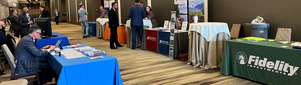 Sponsor tables in the hallway — Fidelity Investments, Sammons, Midland, and event partners